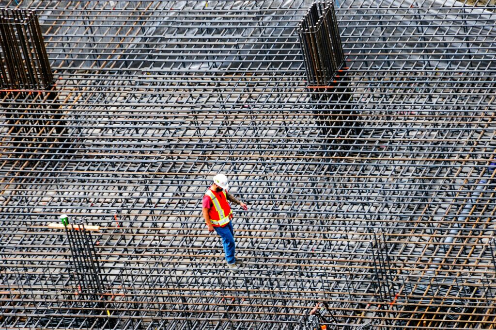 A builder standing on a large steel formwork