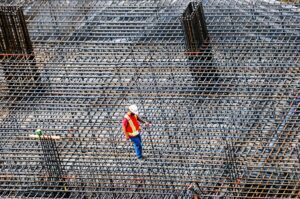 A builder standing on a large steel formwork